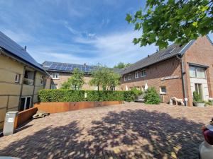 a courtyard of a house with a building with windows at Hof Kricheleberg in Bocholtz