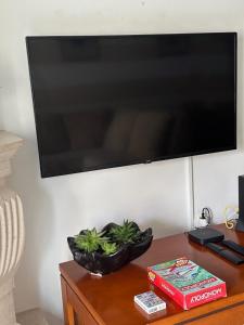a flat screen tv on a wall above a table at Praia - Mar in Ovar