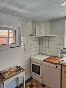 a small kitchen with a stove and a sink at Maison d'Argonne in Brécy-Brières
