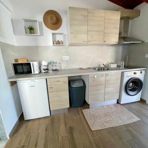a kitchen with a sink and a microwave at Kallisti House in Nea Vrasna