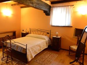 a bedroom with a bed and a window at Torretta di Bassano in Rivergaro