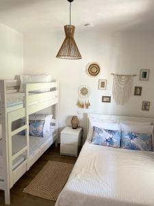 a bedroom with two bunk beds and a lamp at Kallisti House in Nea Vrasna