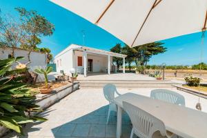 a patio with a white table and chairs at Baglivi's Flat in Torre Specchia Ruggeri
