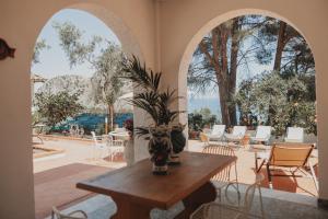 a room with a table and chairs and a patio at Villa Totò Resort in Cefalù