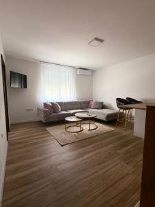 a living room with a couch and a table at Vila Šarić in Doglodi