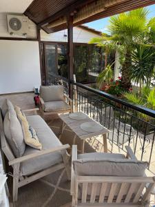 a patio with chairs and a table on a balcony at Kallisti House in Nea Vrasna