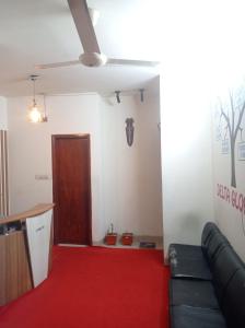 a living room with a couch and a red carpet at One Private Room Near Dhaka Airport in Dhaka