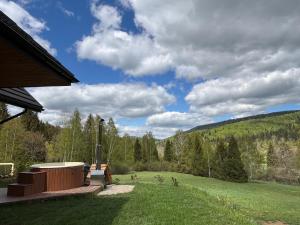 a backyard with a view of a field and trees at Chata pod Jelenim Skokiem in Cisna +17 photos