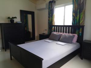 a bedroom with a bed with two books on it at Caribbean Court E1 in Kralendijk +14 photos