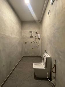 a bathroom with a white toilet in a room at Surf Arugam in Arugam Bay +39 photos