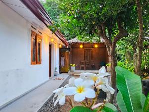 a house with white flowers in front of it at Casa Cayena - Tangalle in Tangalle