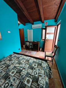 a bedroom with blue walls and a bed and a chair at Avalon in Pietrelcina +20 photos