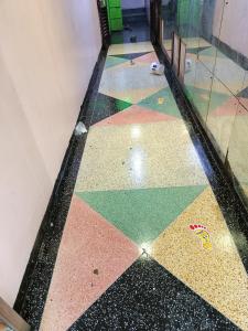 a room with a tiled floor with different colors at City Brisa cbd in Nairobi