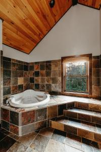 a large bathroom with a tub and a window at Red Tara Sanctuary in Catskill +45 photos