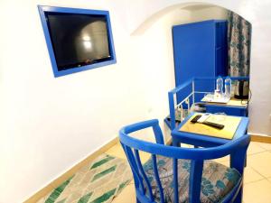 a room with a blue chair and a table at kanabesh hotel in Sharm El Sheikh