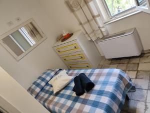 a bedroom with a bed with a sink and a refrigerator at Casa Contadina in Oristano