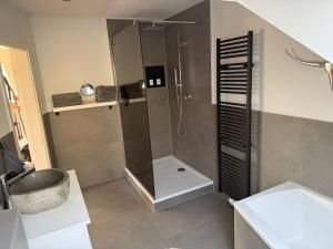 a bathroom with a shower and a sink at Ferienwohnung Monteurwohnung in Lüdenscheid +4 photos