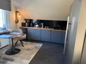 a small kitchen with a table and a refrigerator at Ferienwohnung Monteurwohnung in Lüdenscheid