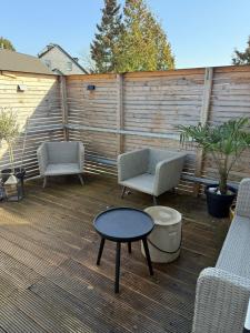 a patio with two chairs and a table on a deck at Ferienwohnung Monteurwohnung in Lüdenscheid