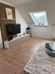 a living room with a flat screen tv and a skylight at Ferienwohnung Monteurwohnung in Lüdenscheid