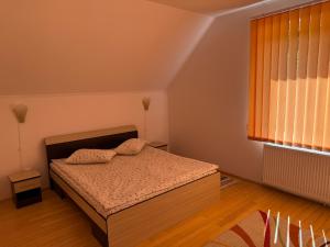 a bedroom with a bed with two pillows on it at Vila Gemenii in Sovata +36 photos
