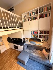 a living room with a couch and book shelves at Cute, Quiet and Central - Self Check In in Bad Ischl