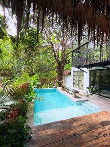 a swimming pool in the middle of a garden at Daya Villa in Kampot