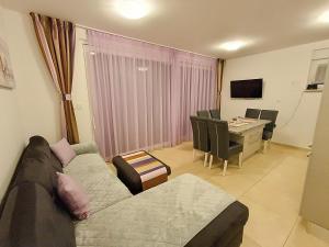 a living room with a couch and a table at Apartment Villa Vala in Malinska
