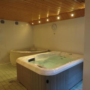 a jacuzzi tub in a room with a toilet at Village vacances de Valmeinier "Les Angeliers" in Valmeinier