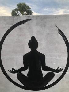 a painting of a person sitting in meditation at Thambili cabanas whisky point in Arugam Bay