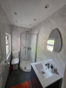 a bathroom with a sink and a shower and a toilet at The Coastal Nest in Folkestone +24 photos
