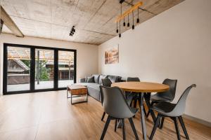 a living room with a table and a couch at SenWood House in Zubrzyca Dolna