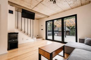 a living room with a couch and a table at SenWood House in Zubrzyca Dolna