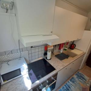 an overhead view of a kitchen with white cabinets at E & E apartment in Koper