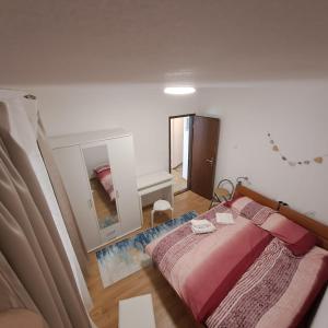 a bedroom with a bed and a large mirror at E & E apartment in Koper