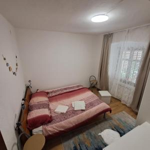 a bedroom with a bed with two towels on it at E & E apartment in Koper
