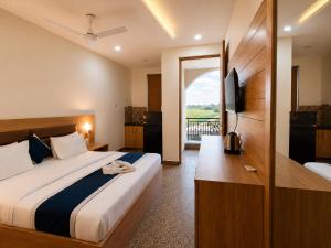 a hotel room with a large bed and a balcony at Hotel Devi Ram Atithi Bhawan Near Banke Bihari Mandir in Vrindāvan