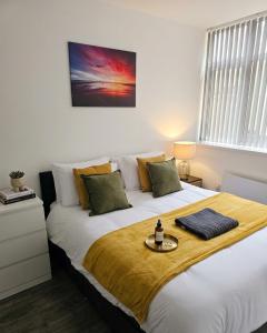 a bedroom with a large bed with a tray on it at Stylish 1 & 2 Bed Apartment - Desborough - Kettering - Sleeps up to 5 - Free Parking, - WIFI - Contractors, Professionals, Families and Relocators - By The Home Makers Hub in Kettering +28 photos