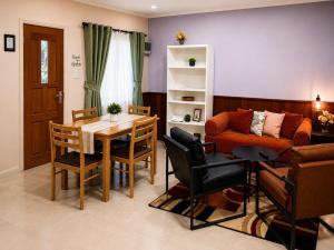 a living room with a table and chairs and a couch at DOLFIJN STUDIOS 4 Spacious 2BR Apartment Fast WiFi AC North Paramaribo in Paramaribo