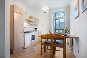 a kitchen with a table and a dining room at Herrenhaus Carolinenhof in Groß Plasten