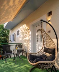 a porch with a hammock on a patio at FLISVOs 70 m από την θάλασσα in Erateini