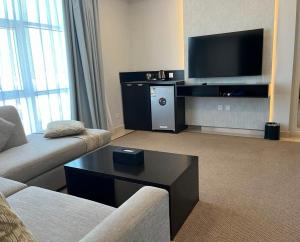 a living room with a couch and a tv at DAM hodoo دام الهــــــــدوء in Al Khobar