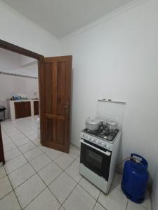 a kitchen with a stove and a refrigerator at Quinta de 4 Pilares in Canavial