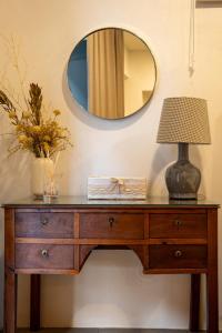 a dressing table with a lamp and a mirror at Provesende Douro Villas -Pateo Douro in Provesende +14 photos