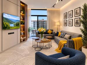 a living room with a couch and a tv at Toot Suites in Abha