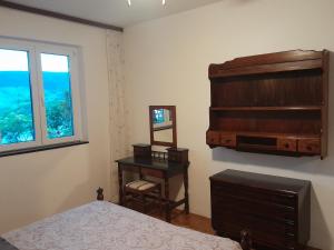 a bedroom with a bed and a dresser and a mirror at Vake in Herceg-Novi