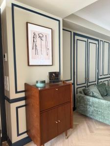 a living room with a dresser and a bed at L'ODE A PIERRE - Chambres d'hôtes in Dax