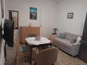 a living room with a table and a couch at Vake in Herceg-Novi