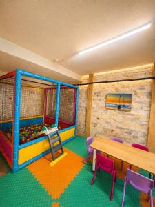 a room with a bunk bed and a table and chairs at Grand Rimedya Hotel in Karabağ