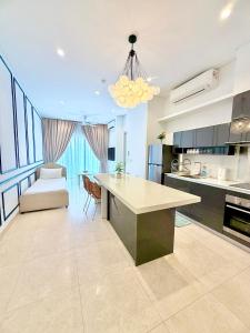 a large kitchen with a table and a couch at Lucentia residence luxury suites in Kuala Lumpur